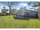 Large backyard with patio, grill, and plenty of grass at 300 S Brighton Dr, Port Orange, FL 32127