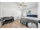 Bedroom with crib, double bed, and wood floors at 300 S Brighton Dr, Port Orange, FL 32127