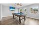 Game room features a pool table, wood-look floors, and plenty of natural light at 300 S Brighton Dr, Port Orange, FL 32127