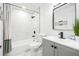 Modern bathroom with white marble-look tile and gray vanity at 3012 Amherst Ave, Orlando, FL 32804