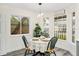 Bright breakfast nook with a round table and green chairs near large windows at 3012 Amherst Ave, Orlando, FL 32804