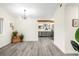 Open concept dining area with wood-look floors and a view of the kitchen at 3012 Amherst Ave, Orlando, FL 32804