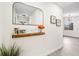 Modern entryway with a floating shelf, mirror, and fresh flowers at 3012 Amherst Ave, Orlando, FL 32804