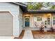 Quaint front porch with blue door, decorative wreath, and comfy seating at 3012 Amherst Ave, Orlando, FL 32804