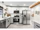 Stylish kitchen featuring white cabinets, stainless steel appliances, and gray lower cabinets at 3012 Amherst Ave, Orlando, FL 32804