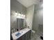 Well-lit bathroom featuring a granite vanity and modern fixtures at 3367 S Kirkman Rd # 1116, Orlando, FL 32811