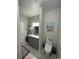 Bathroom with gray vanity, marble countertop, and toilet at 3367 S Kirkman Rd # 1116, Orlando, FL 32811