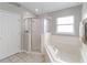 Bathroom with shower, tub, and tile floor at 3418 Gator Bay Creek Blvd, St Cloud, FL 34772