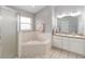 Bathroom with corner tub, double vanity, and shower at 3418 Gator Bay Creek Blvd, St Cloud, FL 34772