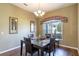 Dining area with a glass-top table and four chairs, hardwood flooring at 346 Hickory Springs Ct, Debary, FL 32713