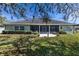 House exterior view showcasing a screened porch and landscaping at 346 Hickory Springs Ct, Debary, FL 32713