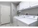 Laundry room with washer, dryer, cabinets, and utility sink at 346 Hickory Springs Ct, Debary, FL 32713