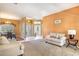 Living room with light beige carpet and walls, and a comfortable couch at 346 Hickory Springs Ct, Debary, FL 32713