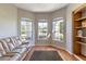 Bright sitting room with hardwood floors, built-in shelving, and a comfortable couch at 346 Hickory Springs Ct, Debary, FL 32713