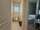 Powder room with toilet and small wooden stool at 3764 Farm Bell Pl, Lake Mary, FL 32746