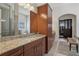 Bathroom boasts granite countertops, ample cabinetry, and a large mirror at 3764 Farm Bell Pl, Lake Mary, FL 32746