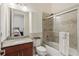 Bathroom featuring granite countertops, a shower-tub combo, tiled walls, and updated fixtures at 3764 Farm Bell Pl, Lake Mary, FL 32746