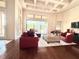 Relaxing living room with red leather sectional and coffered ceiling at 3764 Farm Bell Pl, Lake Mary, FL 32746