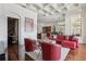 Living area with red leather furniture and view into kitchen area at 3764 Farm Bell Pl, Lake Mary, FL 32746