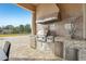 Luxury outdoor kitchen with stainless steel appliances and stone countertops at 3764 Farm Bell Pl, Lake Mary, FL 32746