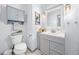 Modern bathroom with gray vanity, white toilet, and decorative mirror at 3788 Brantley Place Cir, Apopka, FL 32703