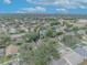 Aerial view showcasing home location in a quiet residential neighborhood with mature trees and city skyline views at 3838 Gatlin Place Cir, Orlando, FL 32812