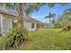 Home with a large backyard and palm trees at 3838 Gatlin Place Cir, Orlando, FL 32812