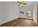 Simple bedroom with wood-look floors and a window at 3838 Gatlin Place Cir, Orlando, FL 32812