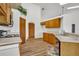 Kitchen with wood cabinets, black appliances, and wood floors at 3838 Gatlin Place Cir, Orlando, FL 32812