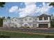 Modern townhome community with two-car garages and attractive landscaping at 4295 Campsite Loop, Orlando, FL 32824