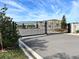 Community entrance with black metal gate and stone pillars at 4303 Campsite Loop, Orlando, FL 32824