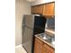 Stainless steel refrigerator in kitchen with wood cabinets at 4653 Cason Cove Dr # 2713, Orlando, FL 32811