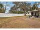 Large backyard with white fence and mature trees at 513 Seminole Ave, Fruitland Park, FL 34731