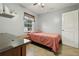 Simple bedroom with a double bed and window at 513 Seminole Ave, Fruitland Park, FL 34731