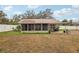 Backyard view of a house with a screened porch and patio at 513 Seminole Ave, Fruitland Park, FL 34731