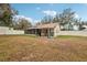 View of house exterior with screened porch and large backyard at 513 Seminole Ave, Fruitland Park, FL 34731