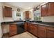 Kitchen with stainless steel appliances and dark wood cabinets at 513 Seminole Ave, Fruitland Park, FL 34731