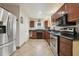 Kitchen with stainless steel appliances and dark wood cabinets at 513 Seminole Ave, Fruitland Park, FL 34731