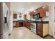 Kitchen with stainless steel appliances and dark wood cabinets at 513 Seminole Ave, Fruitland Park, FL 34731