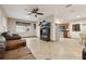 Open concept living room with kitchen view and ceiling fan at 513 Seminole Ave, Fruitland Park, FL 34731