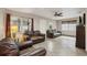 Living room with brown leather couches and ceiling fan at 513 Seminole Ave, Fruitland Park, FL 34731