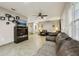 Living room with brown couches, TV stand, ceiling fan at 513 Seminole Ave, Fruitland Park, FL 34731