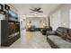 Living room with leather couches, TV stand, and ceiling fan at 513 Seminole Ave, Fruitland Park, FL 34731