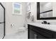 Elegant bathroom with marble flooring and a black vanity at 5265 Forest Edge Ct, Sanford, FL 32771