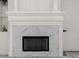 Modern white fireplace with marble surround in living room at 5265 Forest Edge Ct, Sanford, FL 32771