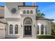 Elegant entryway featuring a grand arched double door and stone accents at 5265 Forest Edge Ct, Sanford, FL 32771