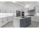 Spacious kitchen with gray island and white cabinetry at 5265 Forest Edge Ct, Sanford, FL 32771