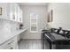 Bright laundry room featuring a marble countertop and modern appliances at 5265 Forest Edge Ct, Sanford, FL 32771