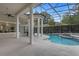 Relaxing patio with covered lanai overlooking a refreshing pool and waterfall feature at 5265 Forest Edge Ct, Sanford, FL 32771