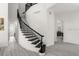 Elegant curved staircase with black iron railings and light wood floors at 5265 Forest Edge Ct, Sanford, FL 32771